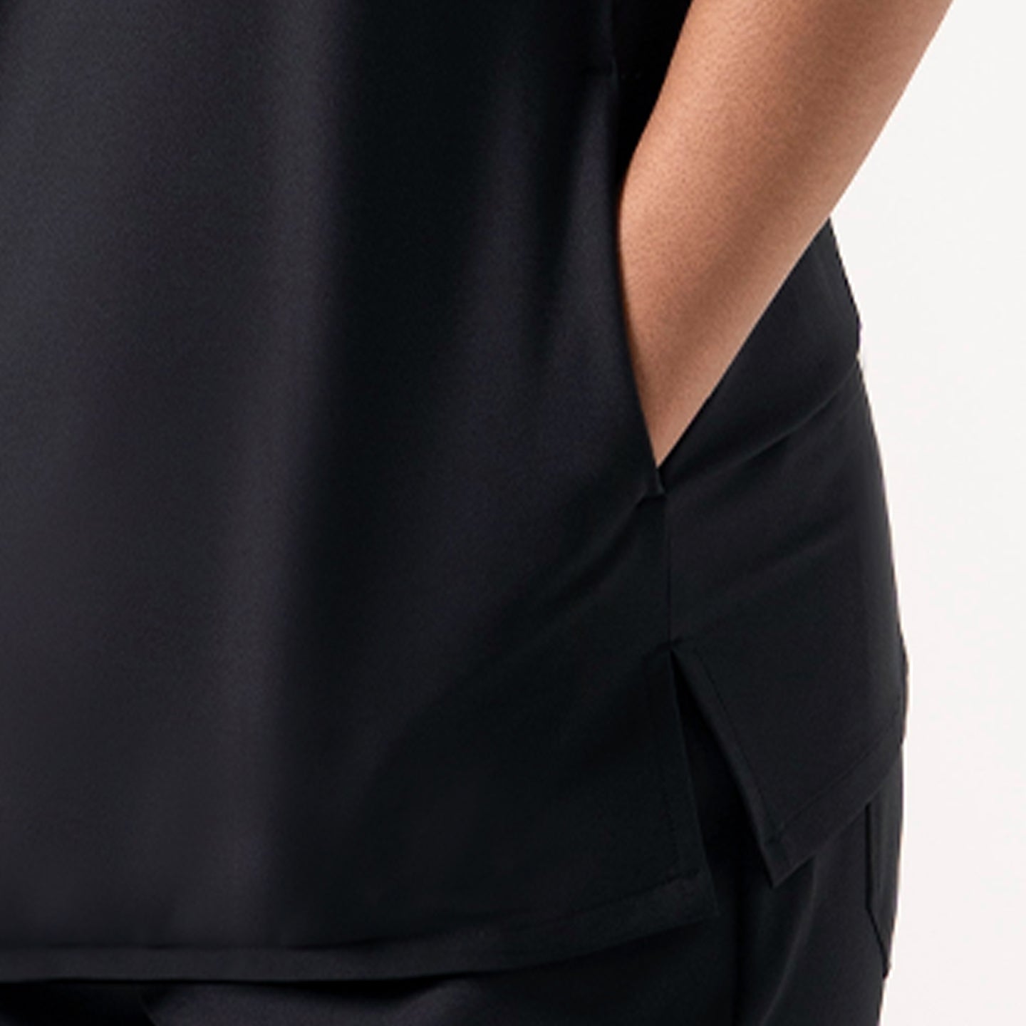Image of Women's Eco Black 3-Pocket Scrub Top fabric and side pocket close-up